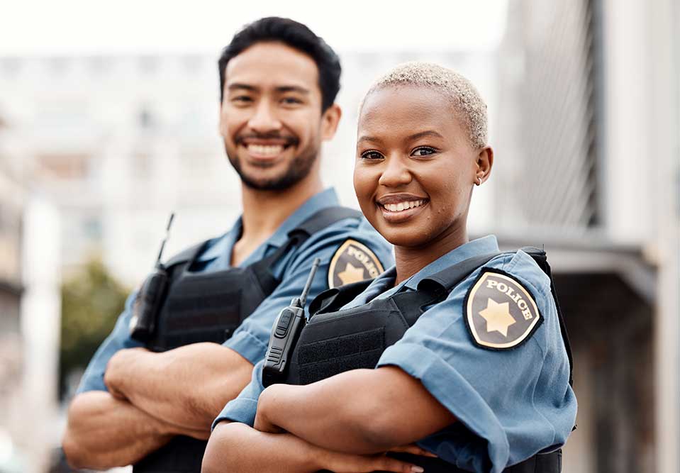 two police officers smiling at the camera