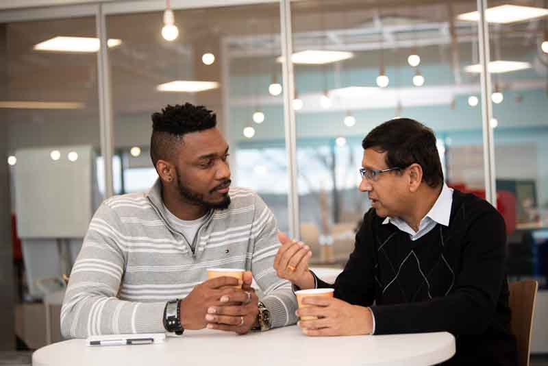two men talking in an office