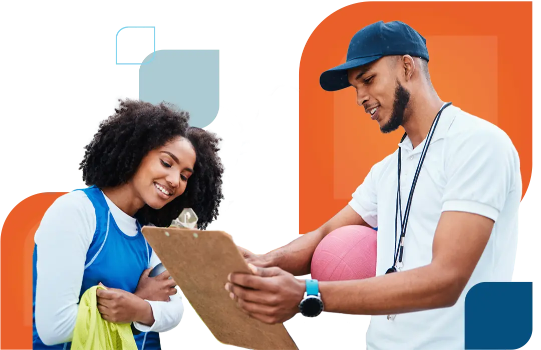 ncaa athlete and coach look at a clipboard