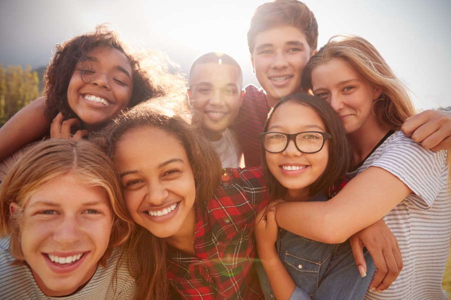 happy group of teens pose for the camera