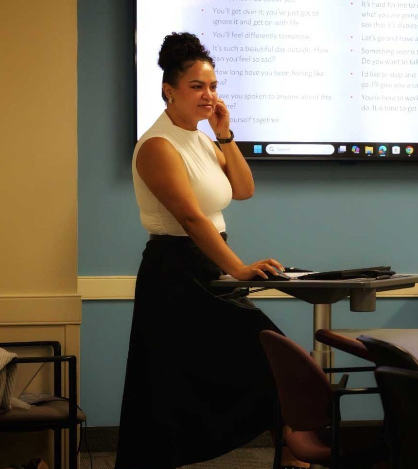 alicia freeman stands at the front of a classroom teaching