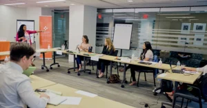 an instructor leads a mental health first aid course in a conference room