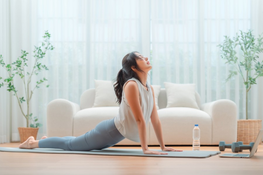 woman doing yoga while coping with post-holiday stress