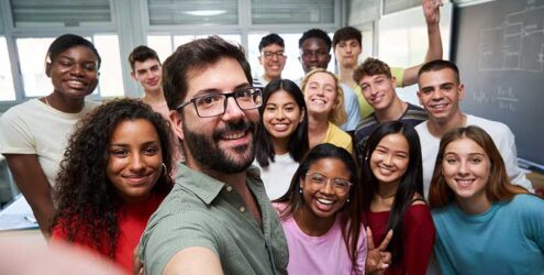 a group of college students take a selfie in a classroom